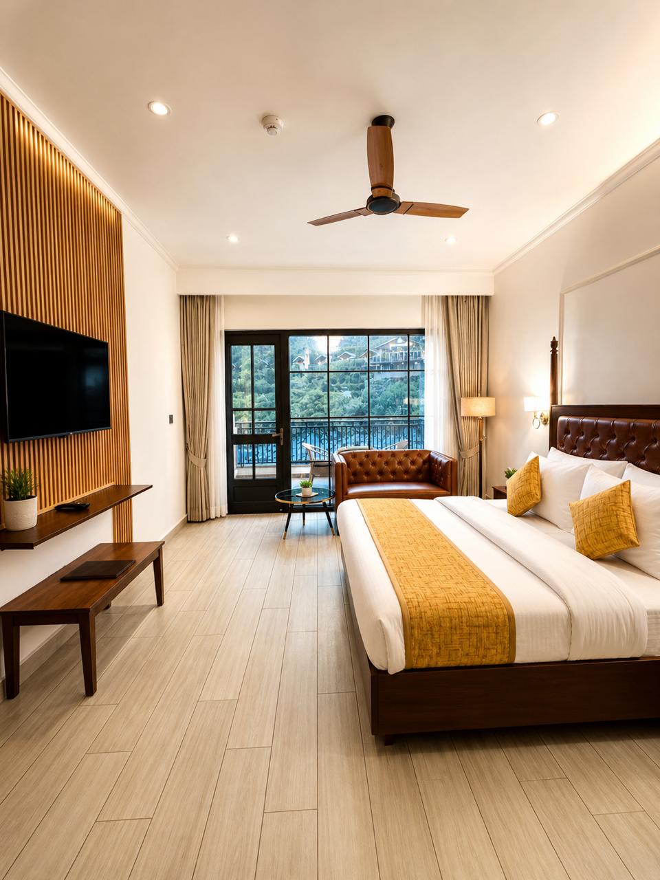 Luxury Room at Tiraya with king bed, leather sofa seating area and river view balcony, Tirthan Valley